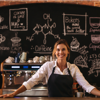 Coffee shop owner standing behind counter